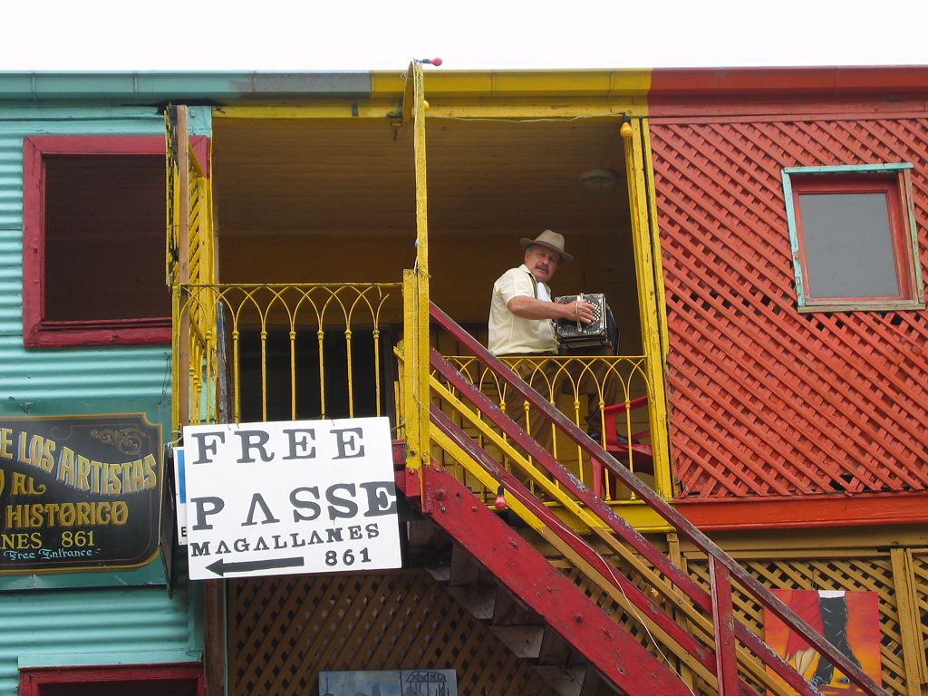 A vendor plays a music box to attract notice, La Boca, Buenos Aires.  Click for next photo.