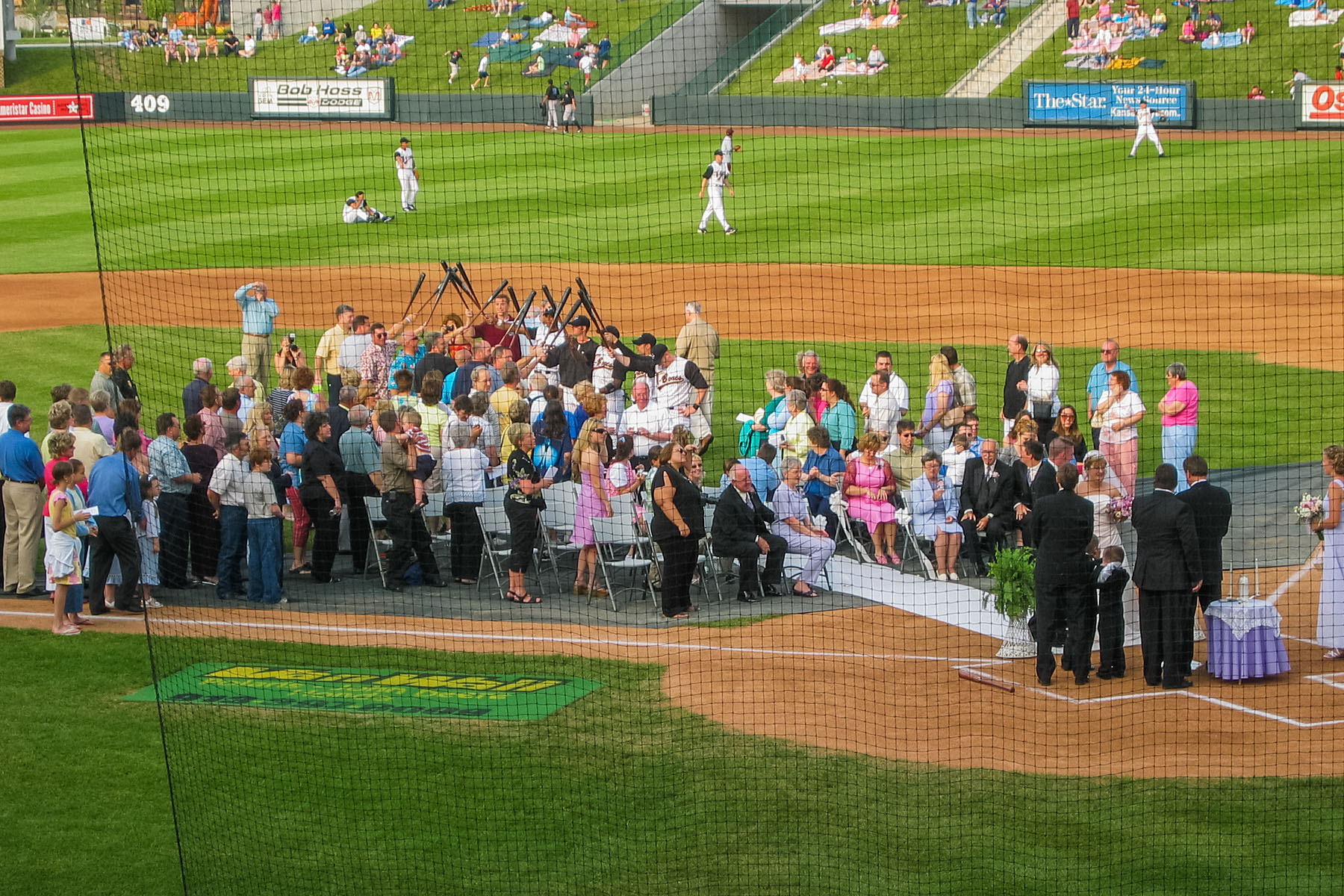 Baseball wedding at Kansas City T-Bones independent league game in KCK.  Click for next photo.