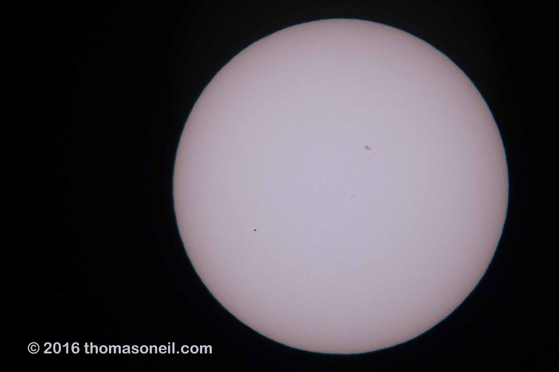 A bad image of the Transit of Mercury, May 9, 2016.  Mercury is the dot toward the lower left.  The day was mostly cloudy/hazy and I was surprised to get anything at all.  For some of my better sun images, see the Partial Eclipse from 2014, the Transit of Venus from 2004, or the Annual Eclipse as seen from Iceland in 2003.  Click for next photo.
