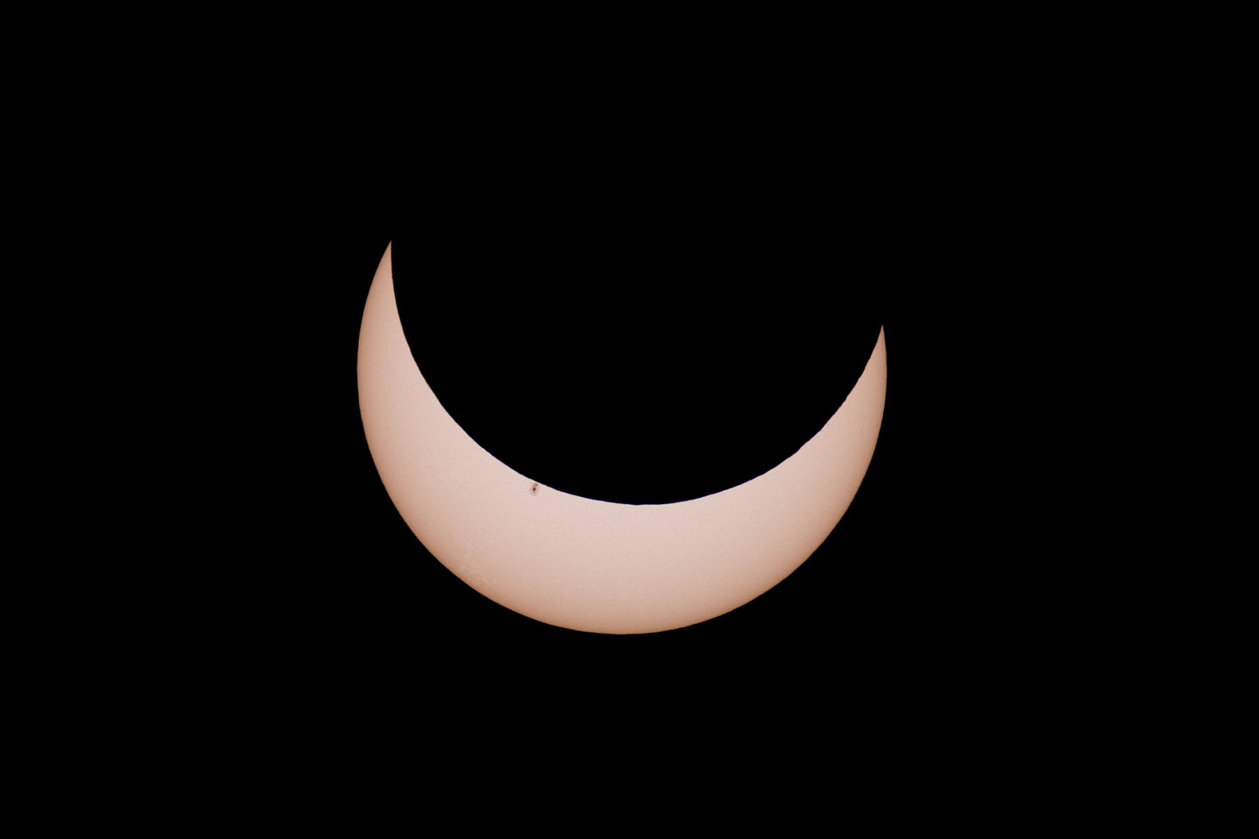 Annular solar eclipse, 19 minutes before peak.  Glass solar filter on Televue 85 telescope, Canon 6D Mark II camera on T-mount, 600mm F7 equivalent.  Click for next photo.