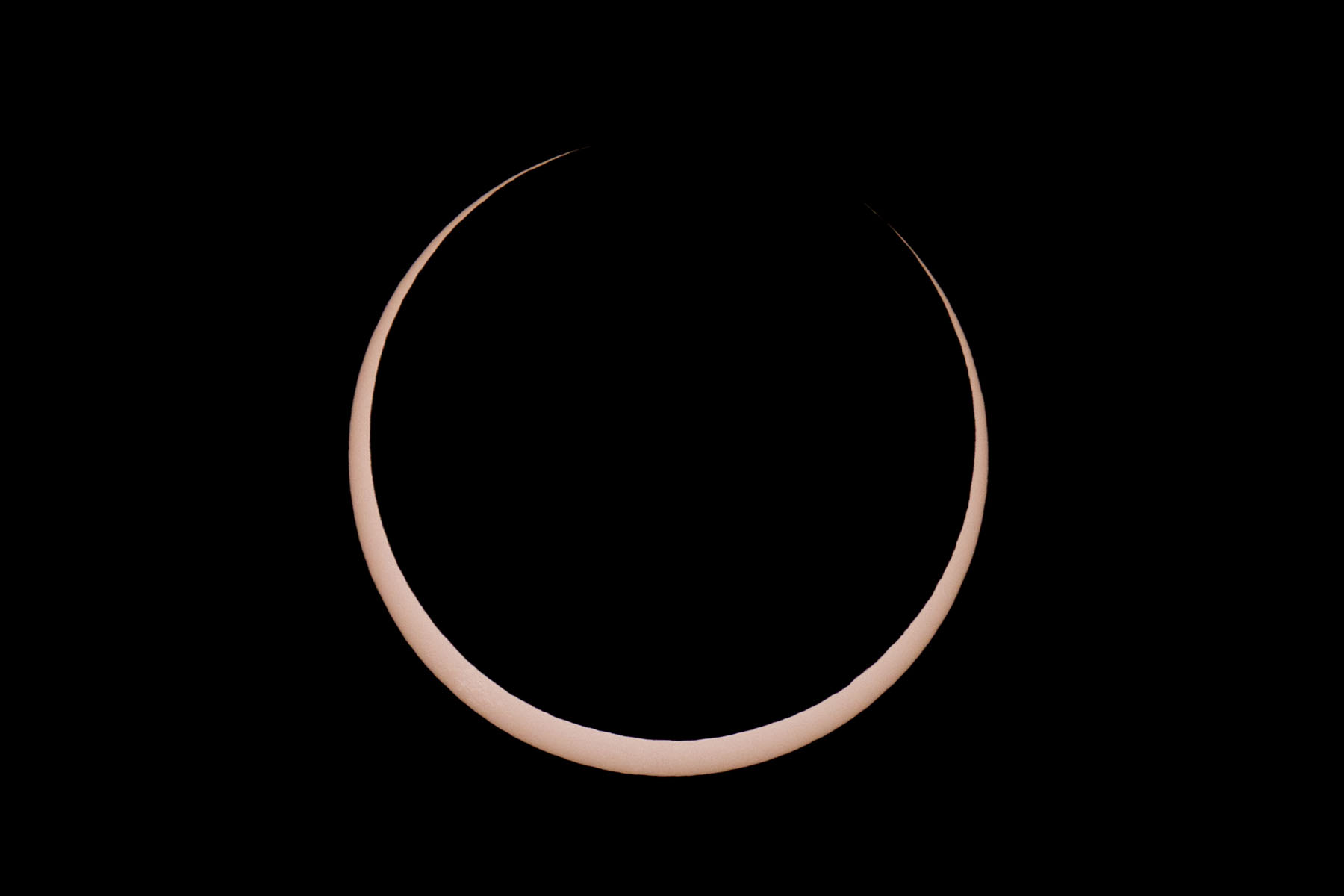 Annular solar eclipse, two minutes before peak.  Glass solar filter on Televue 85 telescope, Canon 6D Mark II camera on T-mount, 600mm F7 equivalent.  Click for next photo.