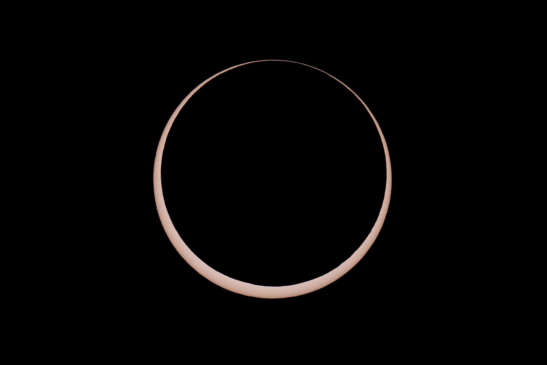 Annular solar eclipse, two minutes before peak.  Glass solar filter on Televue 85 telescope, Canon 6D Mark II camera on T-mount, 600mm F7 equivalent.  Click for next photo.