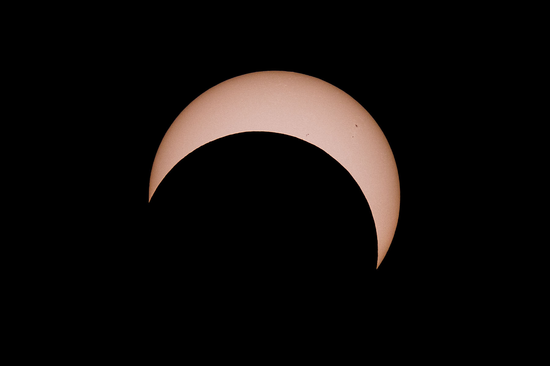 Annular solar eclipse, 21 minutes after peak.  Glass solar filter on Televue 85 telescope, Canon 6D Mark II camera on T-mount, 600mm F7 equivalent.  Click for next photo.