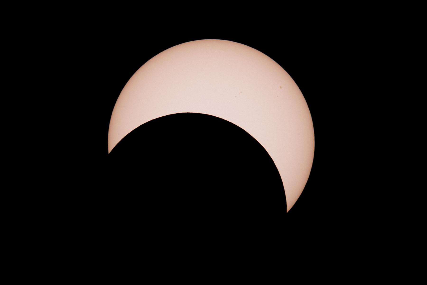 Annular solar eclipse, 32 minutes after peak.  Glass solar filter on Televue 85 telescope, Canon 6D Mark II camera on T-mount, 600mm F7 equivalent.  Click for next photo.