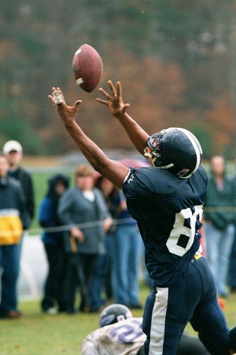 UMass-Dartmouth TE Cameron Barker reaches up into the raindrops to grab a TD pass.