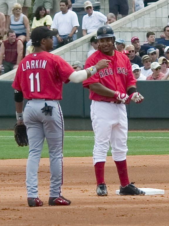 Manny Ramirez says hello to Cincinnati's Barry Larkin after hitting a double, Red Sox spring training, Fort Myers, Florida, 2003.  Click for next photo.
