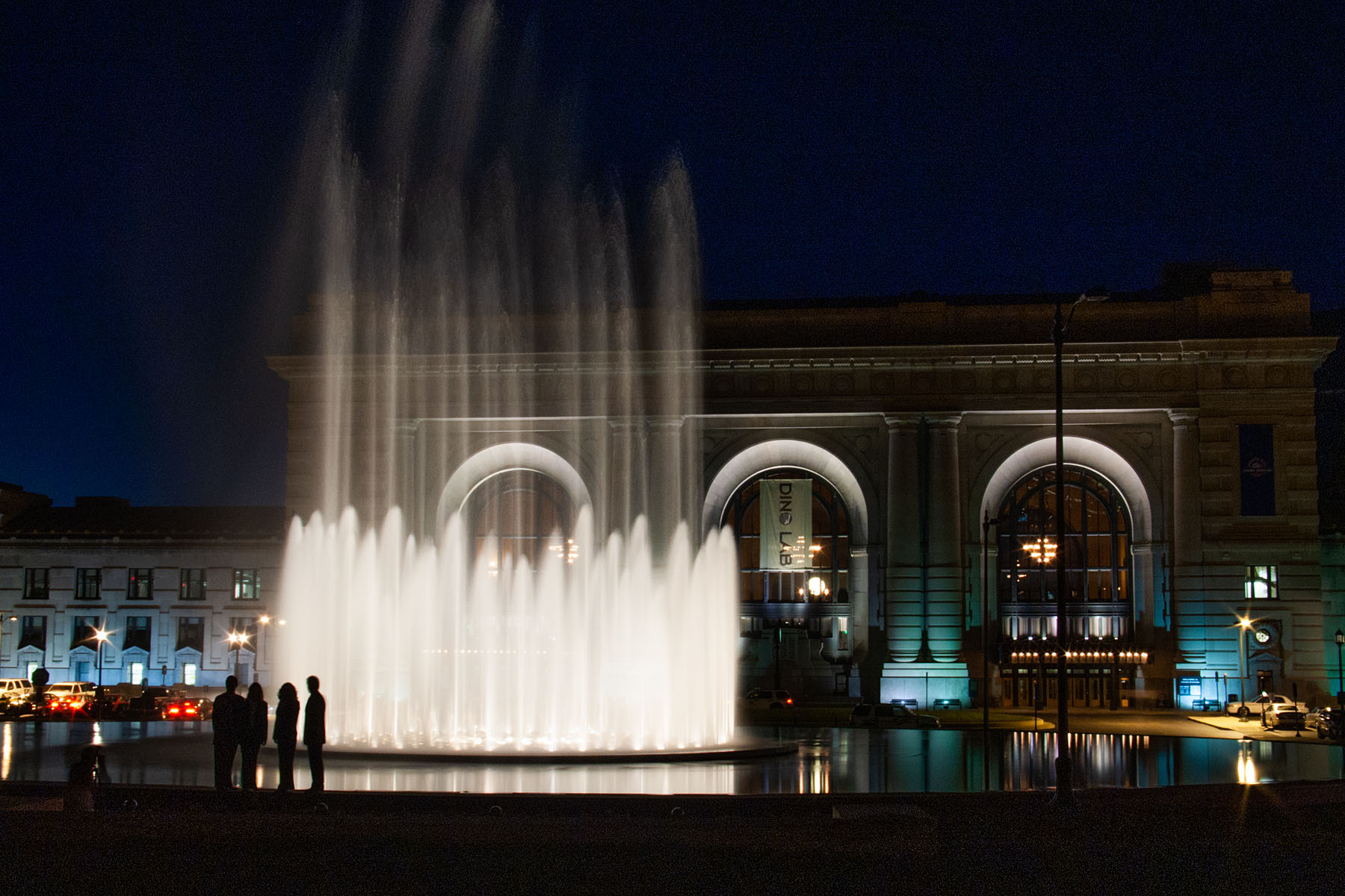 A group watches the fountain in front of Union Station, Kansas City, while waiting for a photographer (not me) to set up a shot.  Click for next photo.