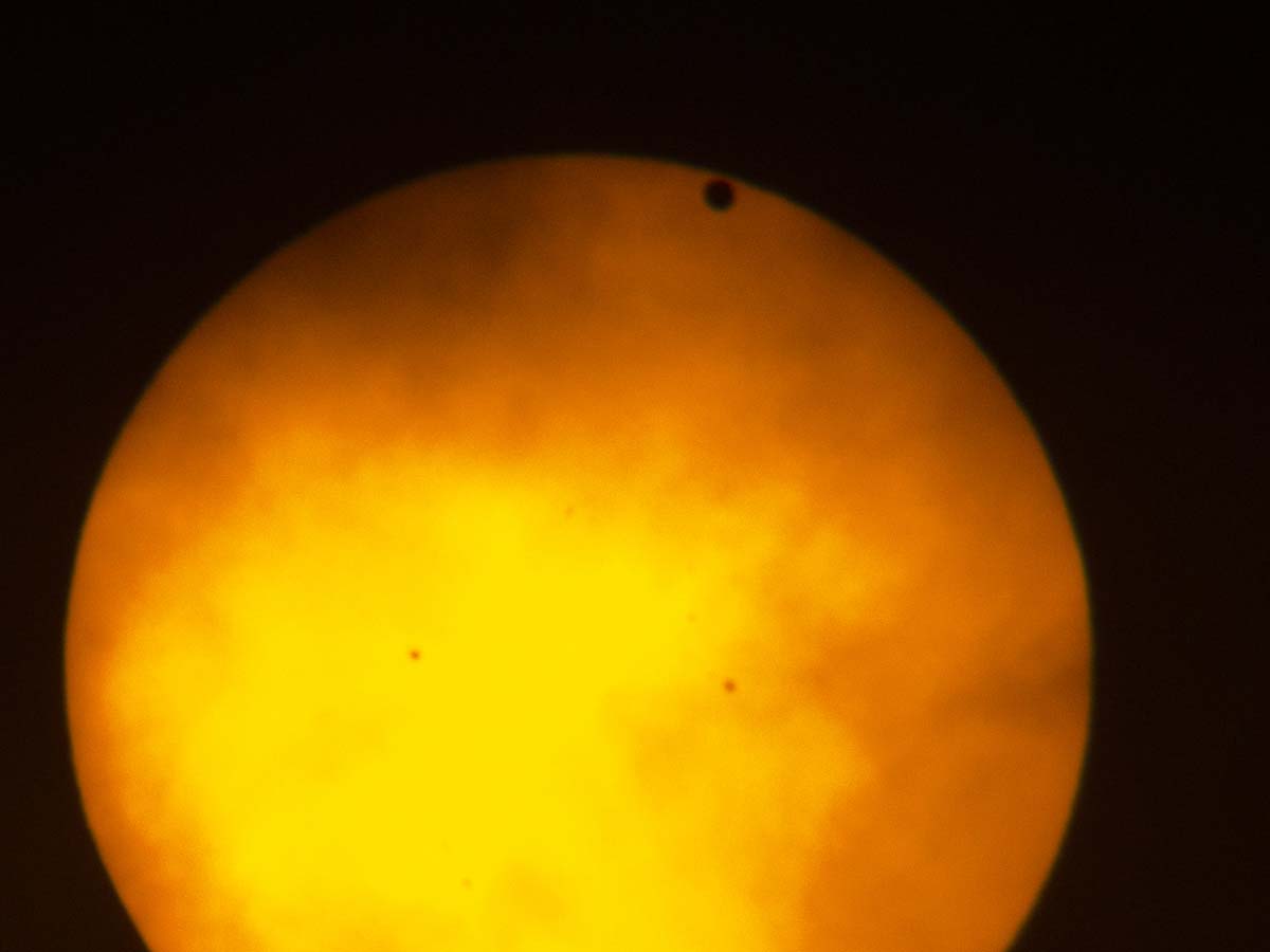Transit of Venus, taken in New York City, June 5, 2012.  I was on extended assignment and didn�t have my big scopes or camera, so I took this with a small handheld camera through my binoculars, which were covered by a solar filter.  I have some somewhat better photos from the 2004 transit.  Transits come in pairs separated by long gaps, so the next transit will not occur until 2117.  Click for next photo.