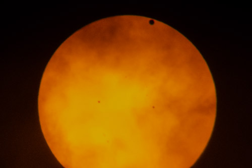 Transit of Venus, taken in New York City, June 5, 2012.  I was on extended assignment and didnt have my big scopes or camera, so I took this with a small handheld camera through my binoculars, which were covered by a solar filter.  I have some somewhat better photos from the 2004 transit.  Transits come in pairs separated by long gaps, so the next transit will not occur until 2117.