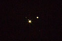 Conjunction of Jupiter and Saturn.  Also visible are the Jovian moons Europa to the right and Io and Callisto to the left.