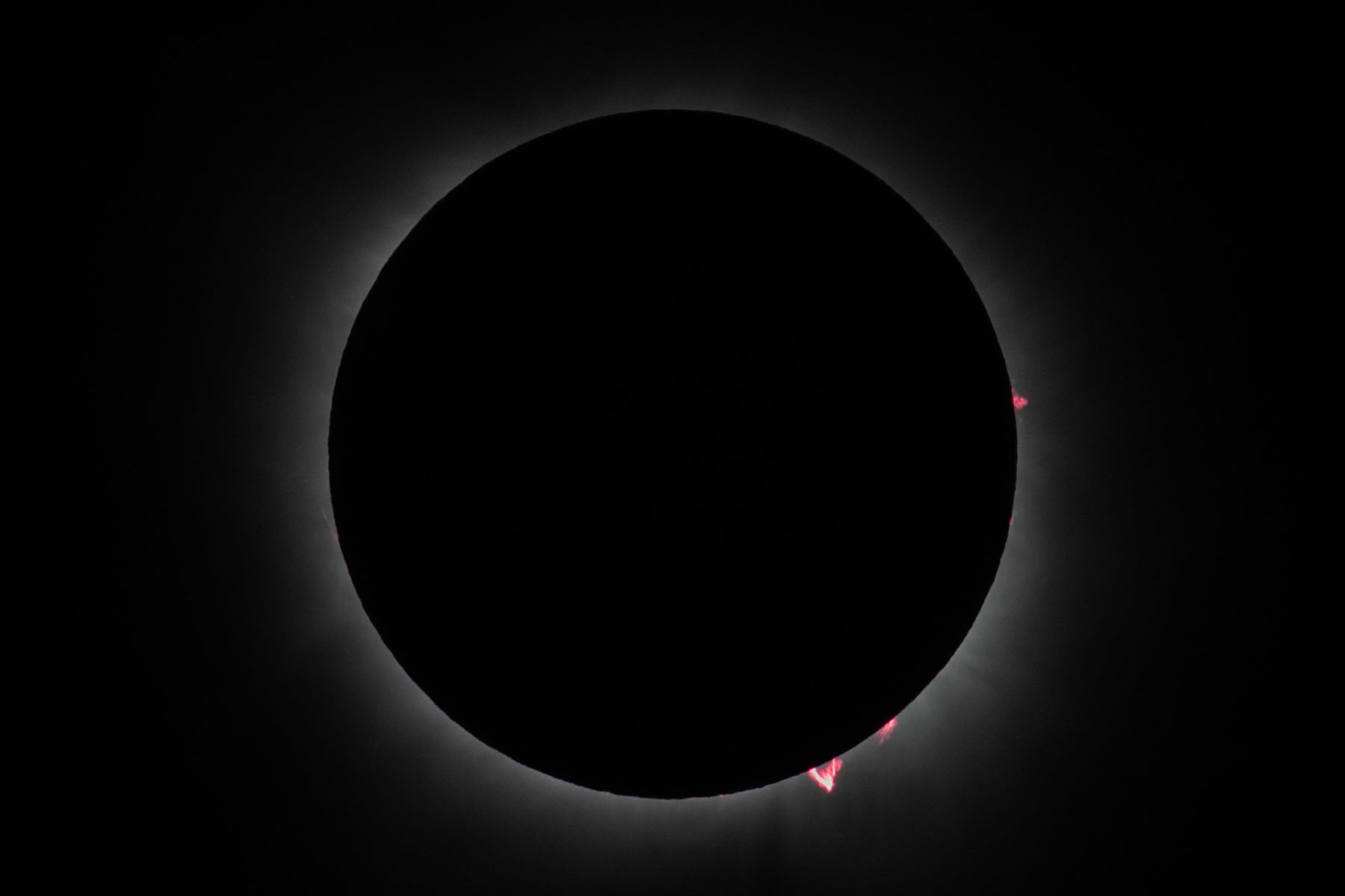 Zoomed out from previous two images.  Getting toward the end of totality, lower right prominence becoming more prominent.  Click for next photo.