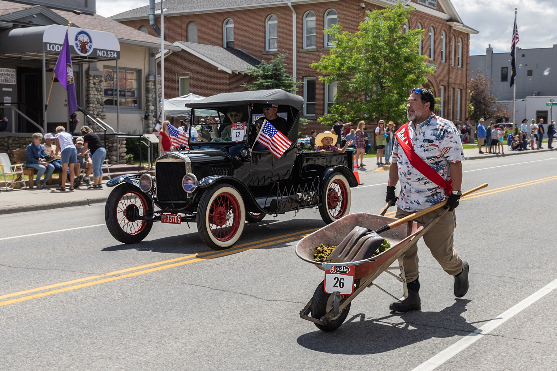 Home of Champions Rodeo Parade, Mayor of Red Lodge on pooper scooper duty following the horses.  Click for next photo.