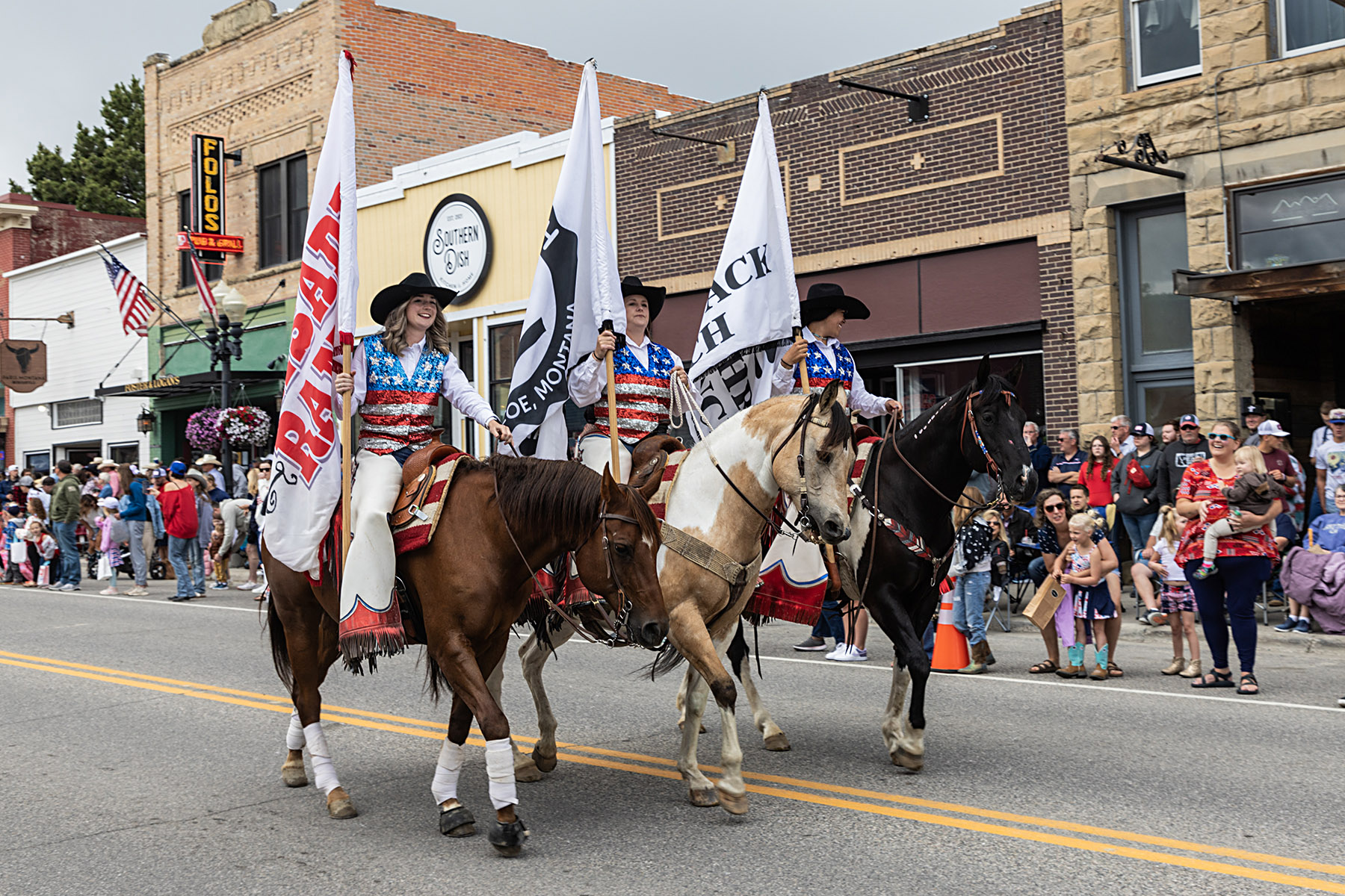 Home of Champions Rodeo Parade.  These riders represent the three ranches which are primary sponsors.
  Click for next photo.